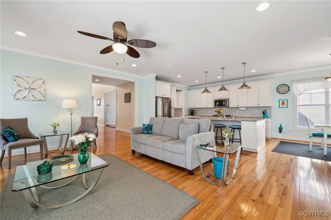 Open concept living with living room, kitchen, and breakfast nook all located in the main living space. Entry of home is through the encased opening in center of picture. | Image 4