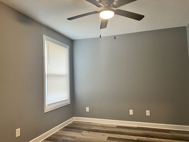 Bedroom 1 with ceiling fan. | Image 9