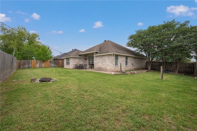 Rear view of property featuring a fire pit, a patio, and brick siding | Image 15