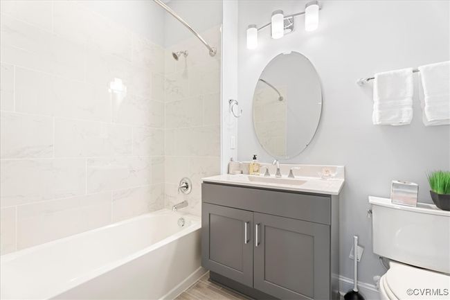 Full bath featuring toilet, vanity, and shower / bath combination | Image 7