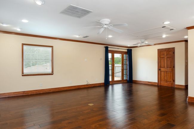 Empty room with attic access, ceiling fan, ornamental molding, recessed lighting, and dark wood finished floors | Image 22