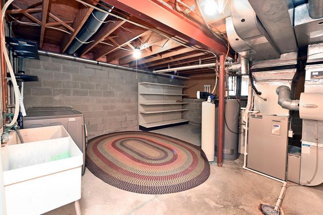 Unfinished Basement Laundry/ Mechanical Room offers ample Storage Area. There is also a large storage closet! | Image 33