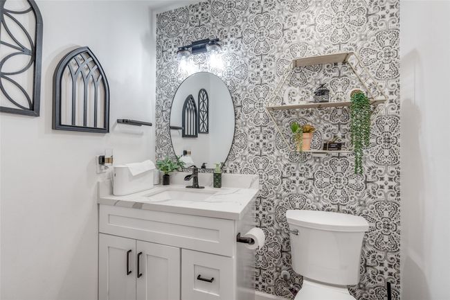 This convenient half bathroom is ideal for guests, offering a stylish and functional space with a modern vanity and clean design. | Image 8
