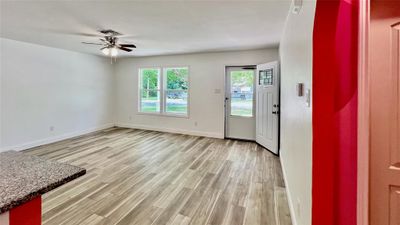 LIVING room with light hardwood / wood-style flooring and ceiling fan | Image 3