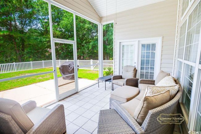Sunroom featuring lofted ceiling and healthy amount of natural light | Image 23