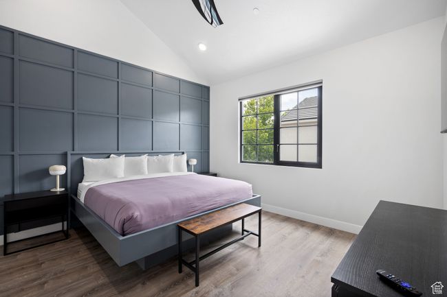 Bedroom with high vaulted ceiling and hardwood / wood-style floors | Image 16