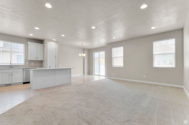Interior space with an inviting chandelier, a wealth of natural light, visible vents, and recessed lighting | Image 12