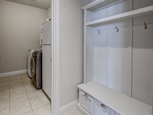 Laundry room featuring washer and dryer and light tile patterned floors | Image 5