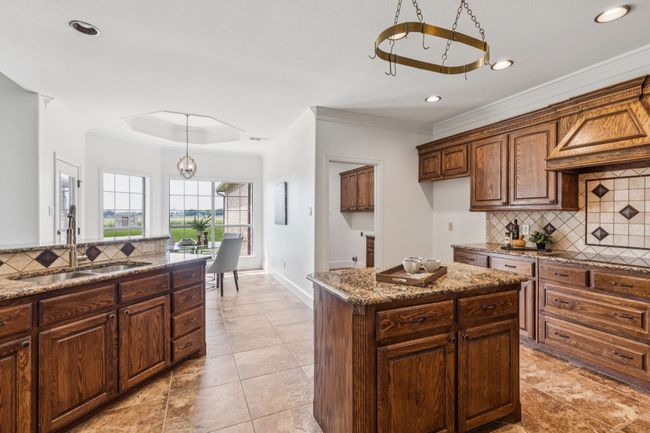 Another view of the kitchen showing the laundry room on the right and your view from the sink | Image 13