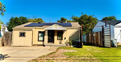 View of front of property with a front yard, solar panels, and a patio area | Image 3