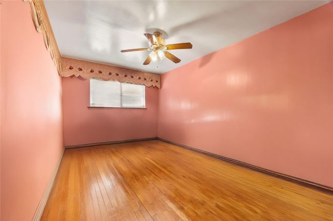 Empty room featuring light wood-style flooring and a ceiling fan | Image 21