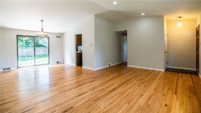 The living and dining rooms flow together to form an open layout. | Image 4