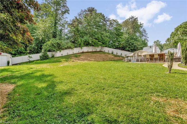 Spacious backyard with 3 storage buildings and wrap-around privacy fence | Image 27