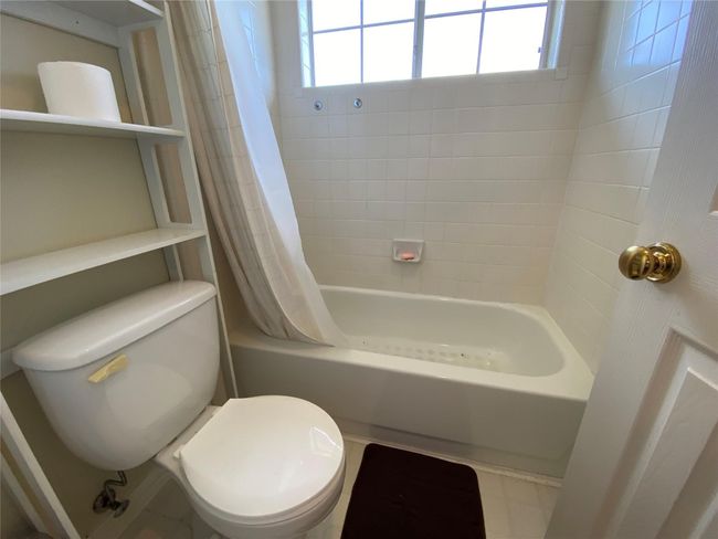 Bathroom featuring shower / bath combination with curtain and toilet | Image 35