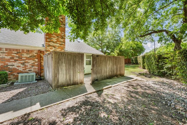 View of outbuilding with a fenced backyard and cooling unit | Image 20