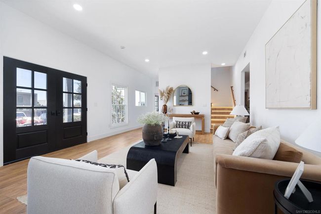 Large living room and entry area, custom fireplace with built in cabinets and floating shelves | Image 21