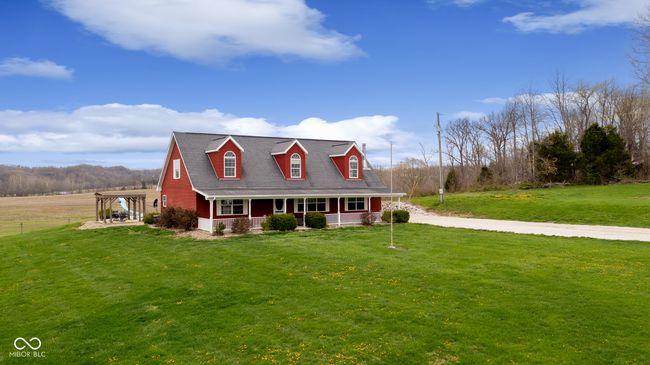 new england style home with a shingled roof, a front lawn, and covered porch | Image 51