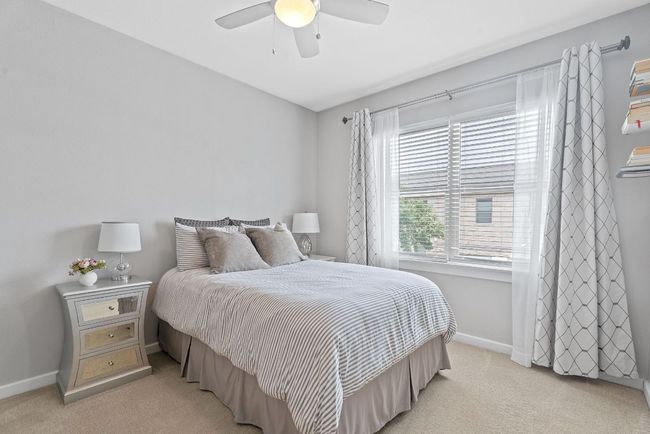 Bedroom with light colored carpet and a ceiling fan | Image 22