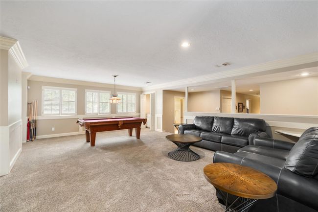 With generous proportions and large windows, the upstairs game room is full of potential—perfect for movie nights, gaming, hobbies, or just a bright space to unwind. A new AC and heater installed in 2024 ensure year-round comfort no matter how you use the space. | Image 26