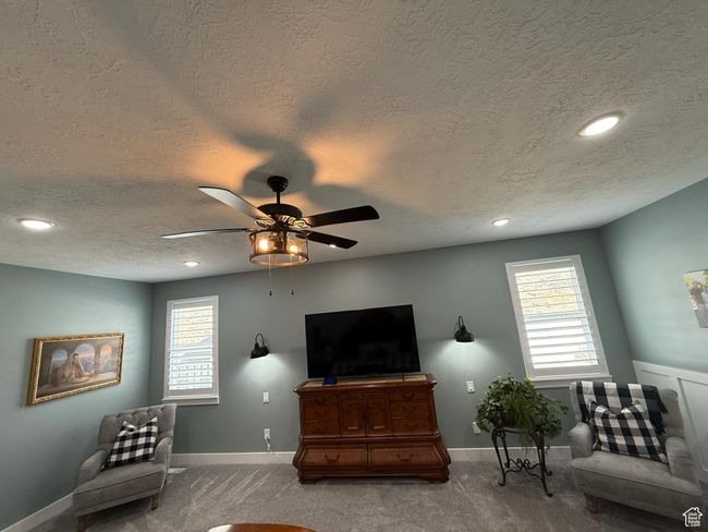Interior space with plenty of natural light, baseboards, carpet floors, and a ceiling fan | Image 33