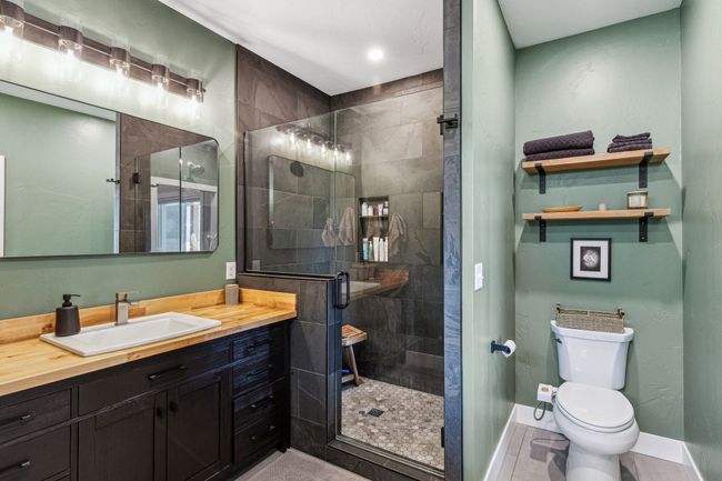 Full bathroom with vanity, a stall shower, toilet, baseboards, and recessed lighting | Image 26