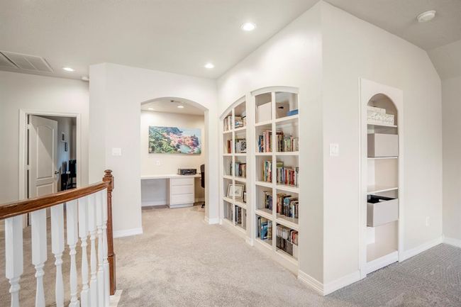 Just off the gameroom area there is a study nook, a wall of built-in bookshelves, and tons of storage for games, TV equipment or movies. | Image 29