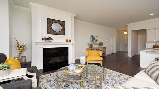 Living room featuring crown molding, a fireplace, and dark wood-type flooring | Image 14