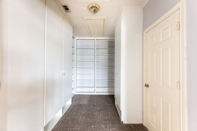 Walk in closet featuring attic access | Image 18