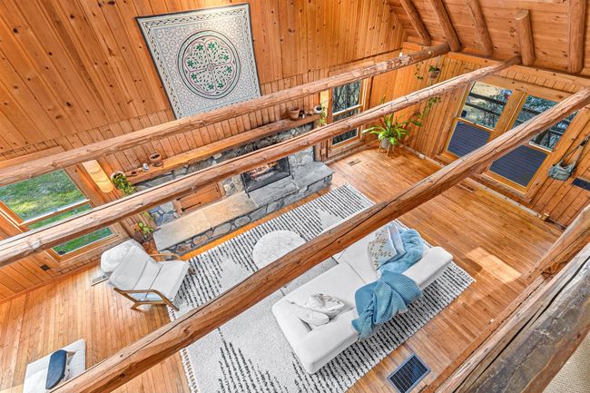 Carpeted bedroom featuring vaulted ceiling, wooden walls, and wood ceiling | Image 24