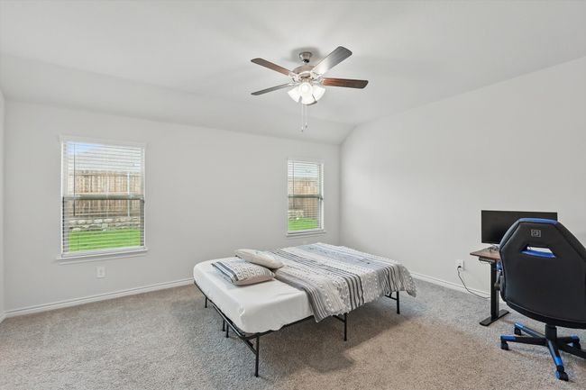 Carpeted bedroom with vaulted ceiling and ceiling fan | Image 20