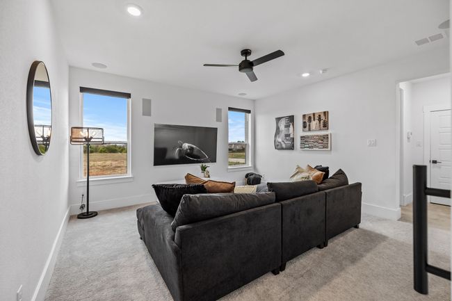 Carpeted living room with ceiling fan | Image 16