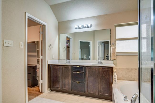 Bathroom featuring a sink, double vanity, and a garden tub | Image 27