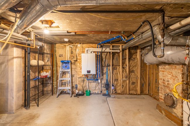 Unfinished below grade area featuring water heater | Image 29
