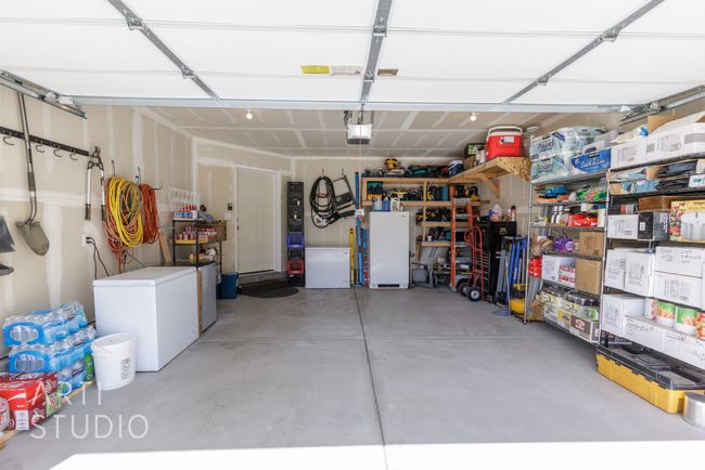 Garage with a garage door opener, refrigerator, and freestanding refrigerator | Image 23