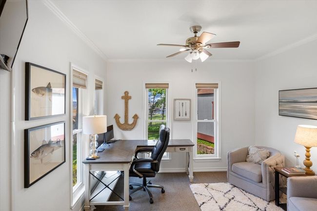Carpeted home office featuring baseboards, ornamental molding, and ceiling fan | Image 17