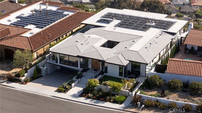 Property features a subterranean, finished three-car garage with epoxy floors, built-in cabinetry and universal EV charging. | Image 33