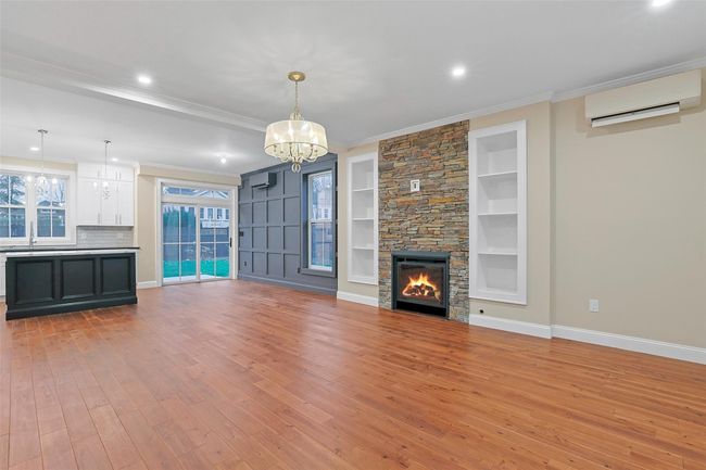 Spacious, open concept living room with stunning Brazilian Acai 3/4 inch harwood flooring, brushed and antiqued. | Image 7