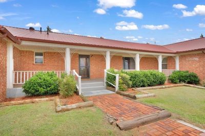 View of exterior entry featuring a yard and a porch | Image 3