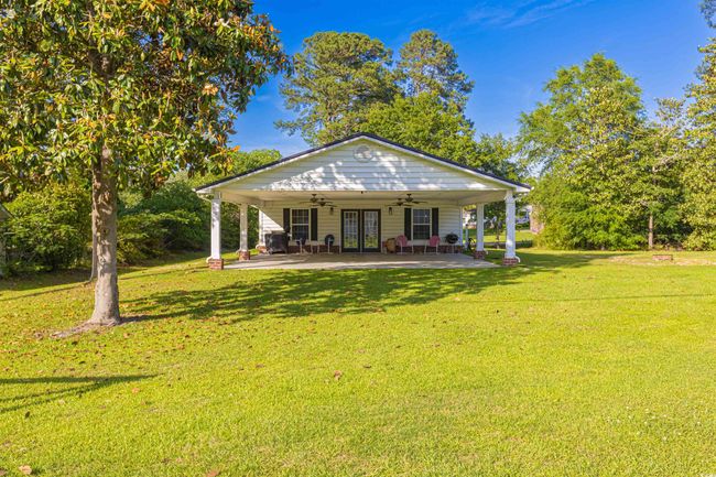Rear view of property with a ceiling fan, a yard, french doors, and a patio | Image 26
