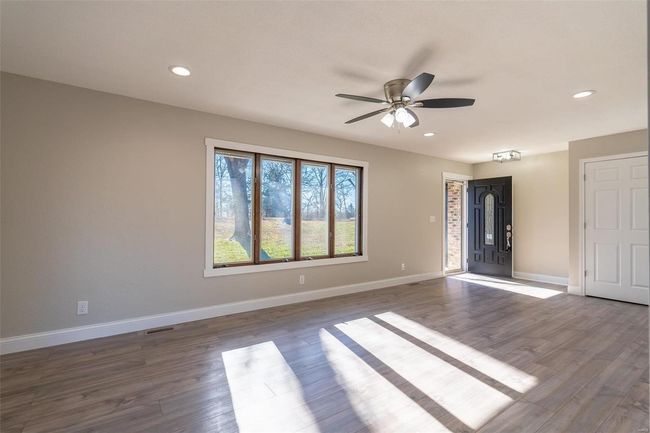Empty room with / wood-style floors and ceiling fan | Image 31