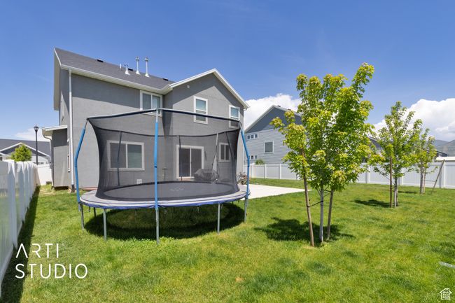 Back of property with a trampoline and stucco siding | Image 29