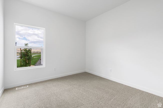 Carpeted empty room featuring visible vents and baseboards | Image 11