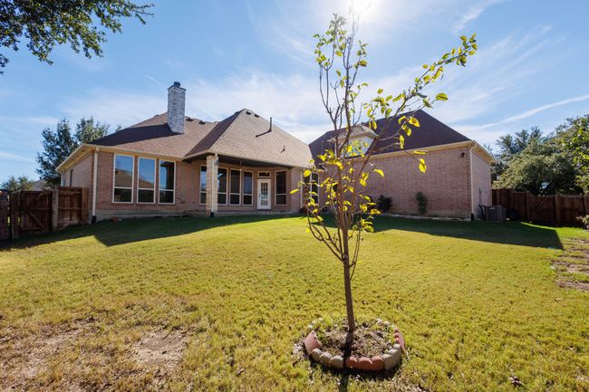 Rear view of house featuring central AC unit and a yard | Image 32