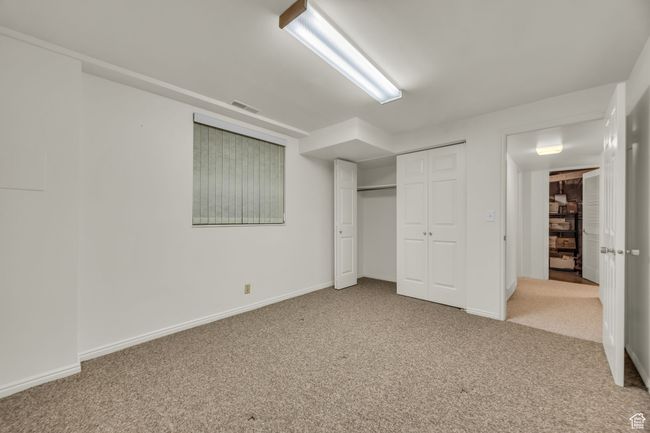 Unfurnished bedroom featuring carpet flooring, baseboards, and visible vents | Image 24