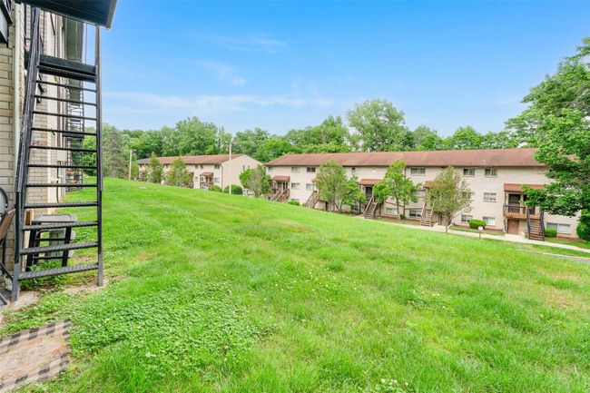 View of green lawn featuring stairway and a residential view | Image 17