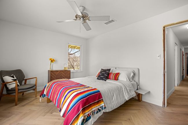 Bedroom with baseboards, visible vents, and a ceiling fan | Image 25