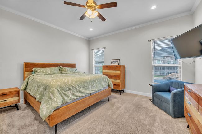 Bedroom with light colored carpet, baseboards, ornamental molding, recessed lighting, and a ceiling fan | Image 18