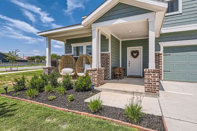 Entrance to property featuring brick siding and covered porch | Image 6