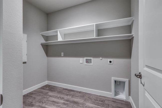 Laundry room featuring hookup for a gas dryer, dark wood-type flooring, washer hookup, and hookup for an electric dryer | Image 10