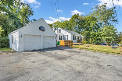 View of front of house with a garage, a front lawn, and an outdoor structure | Image 2